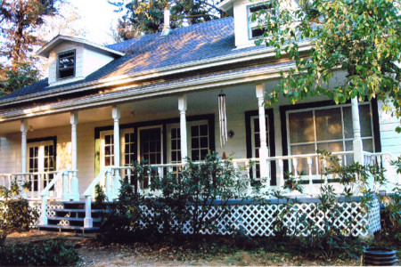 Exterior painting of a charming mendocino cottage house with a wrap around porch.